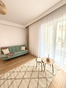 a living room with a couch and a table at Forestis Thermalis in Baile Felix