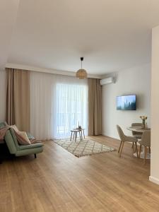 a living room with a couch and a table at Forestis Thermalis in Baile Felix +46 photos