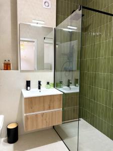 a bathroom with a sink and a shower at Forestis Thermalis in Baile Felix