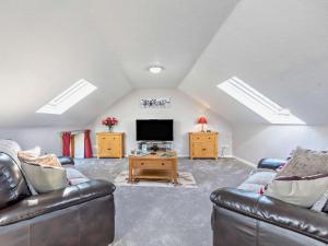 a living room with two couches and a flat screen tv at 2 Bed in Holsworthy oc-00813 in Pyworthy