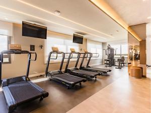 a row of treadmills in a fitness room at Connect João Wallig by My Way in Porto Alegre