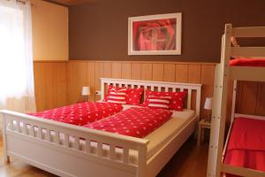 a bedroom with a bed with red pillows and a ladder at FeWo Alte Post in Oberdigisheim