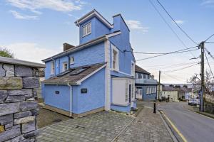 a blue house on the side of a street at 3 Bed in New Quay oc-c29640 in New Quay