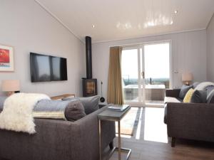 a living room with a couch and a tv at 2 Bed in Anstruther oc-72435 in Anstruther