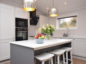 a kitchen with a large white island with stools at 2 Bed in Anstruther oc-72435 in Anstruther