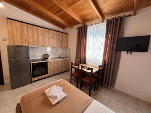 a kitchen and dining room with a table and a kitchen gmaxwell gmaxwell gmaxwell at Emiljano Seaview in Ksamil