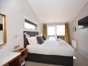 a bedroom with a large white bed and a window at 2 Bed in Anstruther oc-72435 in Anstruther