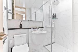 a white bathroom with a toilet and a sink at Balance Seoul Stay in Seoul +16 photos