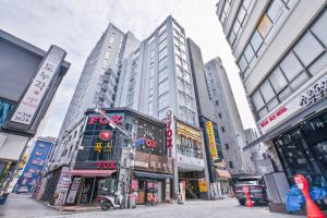 a busy city street with tall buildings at Balance Seoul Stay in Seoul