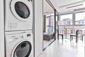 a laundry room with a washer and dryer at Balance Seoul Stay in Seoul