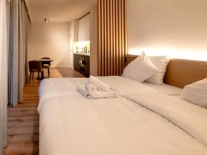 a hotel room with a large white bed with towels on it at Stay at Brussels in Brussels