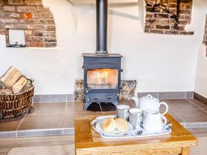 a table with a plate of bread and a stove at 2 Bed in Taunton oc-blafa in Oake