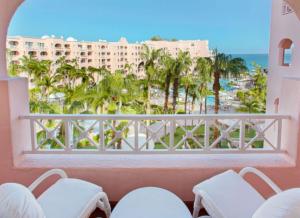 a balcony with chairs and a view of the beach at Owners Studio Suite, REQUEST DATES- see by Clay & Lisa in Cabo San Lucas