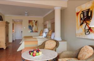 a hotel room with a bed and a table with fruit on it at Owners Studio Suite, REQUEST DATES- see by Clay & Lisa in Cabo San Lucas +42 photos