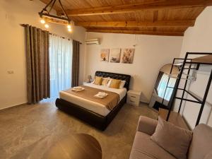 a large bedroom with a bed and a couch at Emiljano Seaview in Ksamil +37 photos