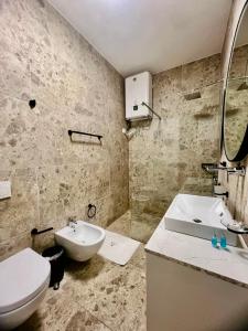 a bathroom with a white toilet and a sink at Veranda Apartment, Green Coast in Palasë +38 photos