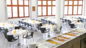 a room with tables and chairs with food on them at SDG Családi Hotel és Konferencia Központ in Balatonszárszó