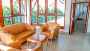 a living room with two chairs and a table at SDG Családi Hotel és Konferencia Központ in Balatonszárszó