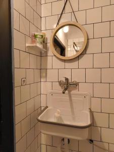 a bathroom with a sink and a mirror at apartmán Port Arthur in Manětín