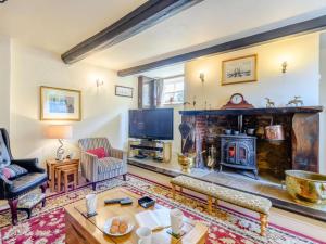 a living room with a fireplace and a tv at 5 Bed in Wareham oc-dc032 in West Lulworth
