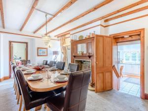 a dining room with a large wooden table and chairs at 5 Bed in Wareham oc-dc032 in West Lulworth