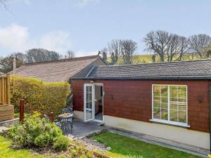a small red brick house with a white door at 5 Bed in Wareham oc-dc032 in West Lulworth