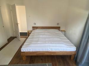 a bed in a room with a wooden bed frame at Ferienwohnung Pauline in Plön