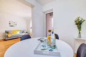 a white dining room with a white table and chairs at Beautiful new apartment Blaz in Mali Lošinj +19 photos