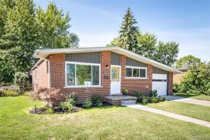 a small brick house with a white garage at Lonnie in Westland
