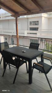 ein schwarzer Tisch und zwei Stühle auf einem Balkon in der Unterkunft Μateo suite in Livadia