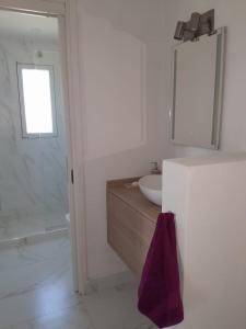a white bathroom with a sink and a mirror at Villa Pi in Miramar +9 photos