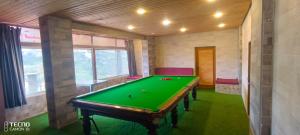 a billiard room with a green pool table at الشريف in Irbid
