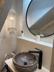 a bathroom with a stone sink and a mirror at ALAIA Mundaka in Mundaka