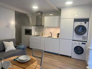 a kitchen and living room with a washer and dryer at ALAIA Mundaka in Mundaka