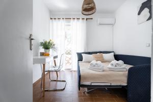 a bedroom with a bed with towels on it at Saronida Coastal Escape 2BR Apartment in Saronida