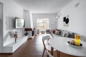 a living room with a couch and a table at Saronida Coastal Escape 2BR Apartment in Saronida