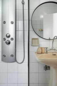 a bathroom with a shower and a sink at Saronida Coastal Escape 2BR Apartment in Saronida +30 photos