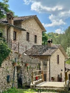 an old stone house with a staircase in front of it at Residenze Ponte in Ponte
