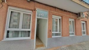 a building with three windows on the side of it at Lofts IFEMA CH in Madrid