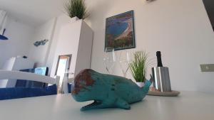 a toy shark sitting on top of a table at Poolvilla Bellavista - Vista Panoramica sul Mare in Costa Paradiso +39 photos