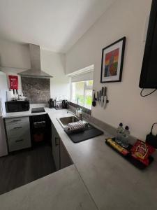 a kitchen with a sink and a counter top at The Éire Escape Countryside Studio near Newgrange & Dublin in Slane
