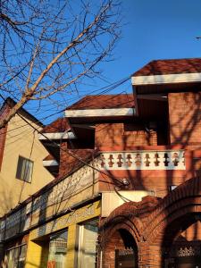 a tall brick building with a tree in front of it at Gaegum Moonlight Stay in Busan