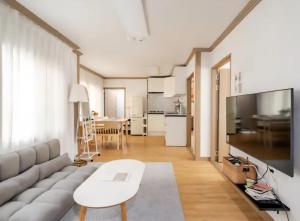a living room with a couch and a table at Gaegum Moonlight Stay in Busan