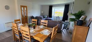 a dining room and living room with a table and chairs at Waterville Links in Waterville
