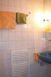 a bathroom with a sink and a towel rack at FeWo Alte Post in Oberdigisheim +26 photos