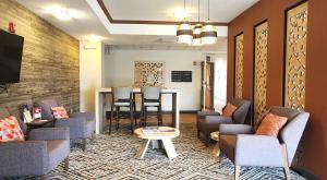 a waiting room with chairs and a table at Candlewood Suites Sheridan by IHG in Sheridan