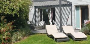 a group of chairs sitting on a patio at Gîte d'Anne et Ulysse in Sept-Frères