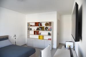 a bedroom with a bed and a tv and a chair at Olga Suite in San Pietro Vernotico