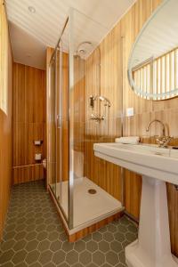 a bathroom with a sink and a shower at Hôtel d'Angleterre in Versailles +65 photos