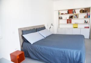 a bedroom with a bed with a blue comforter at Olga Suite in San Pietro Vernotico